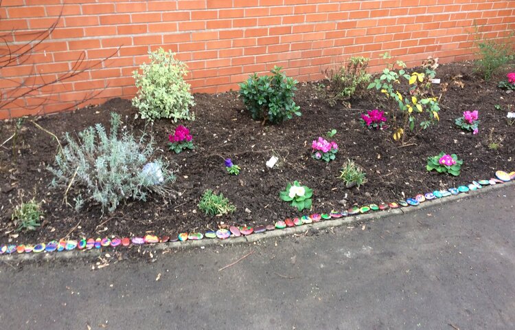 Image of Placing our stones in the Remembrance Garden 