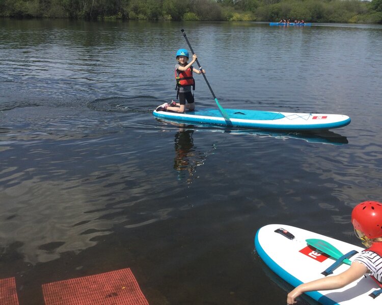 Image of Team 3 paddle boarding 