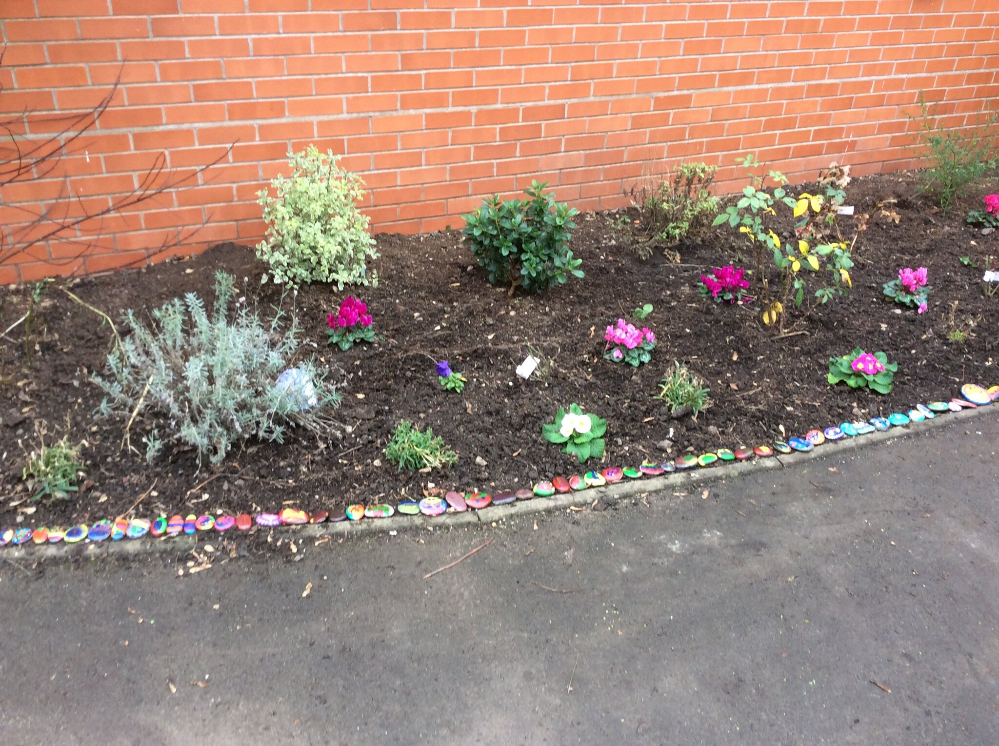 Image of Placing our stones in the Remembrance Garden 