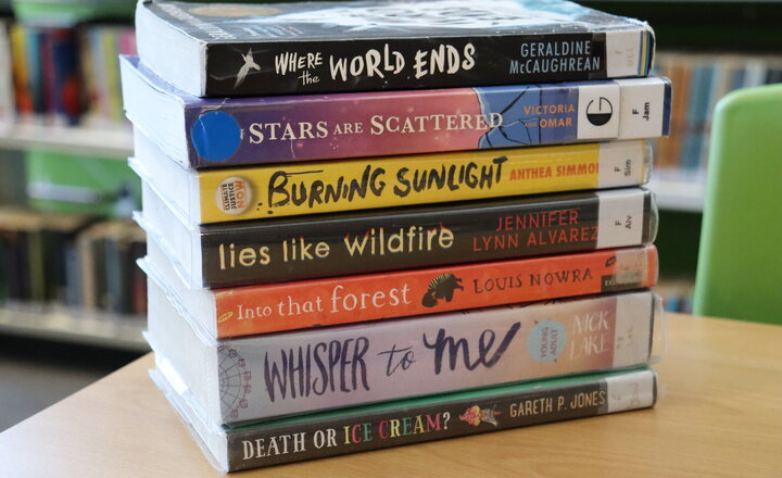 Image of Pupils celebrate National Poetry Day creating book spine poetry in the library