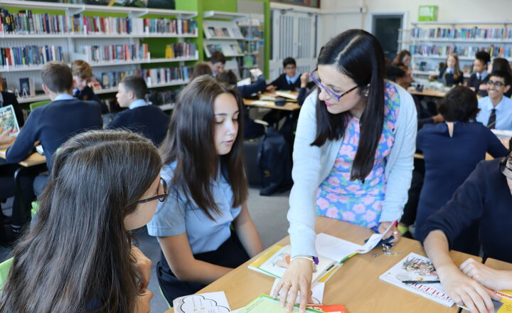 Image of Pupils in year 8 enjoy reading French and Spanish books in the school library