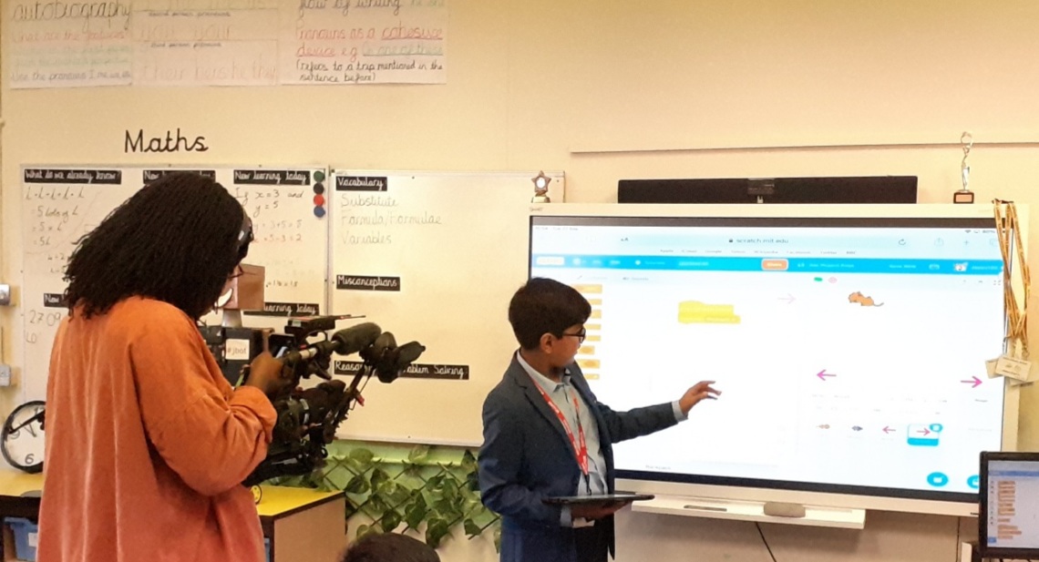 Image of Year 7 pupil filmed by the BBC delivering a coding workshop to primary school pupils