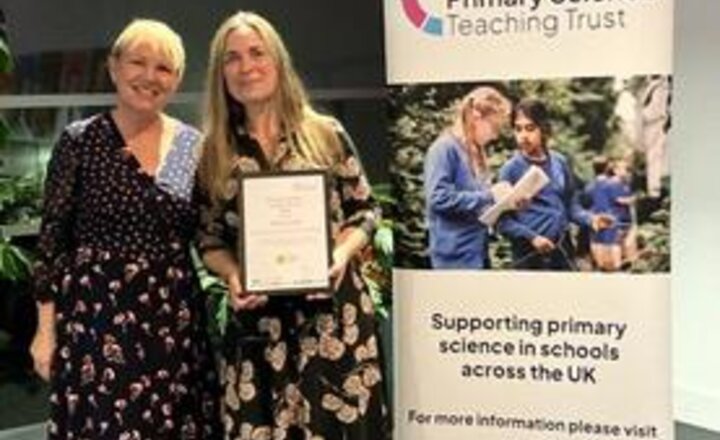 Image of Mrs Grier collects her award