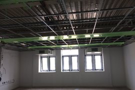 South Buildings classrooms all wired up to receive the teaching wall whiteboards, all plumbing completed, suspended ceilings being fitted along with overhead radiant heat panels.