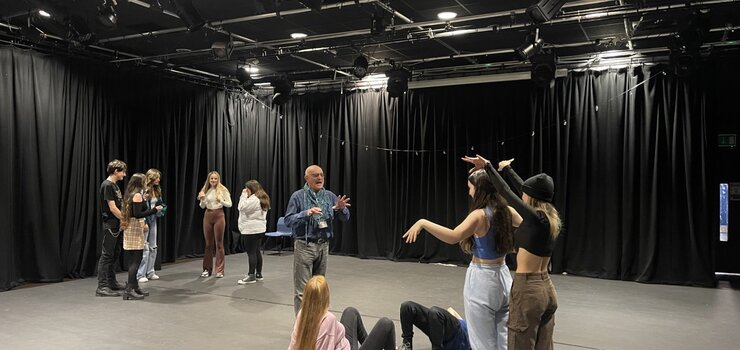 Image of 2 boards and a Passion theatre company visits drama students