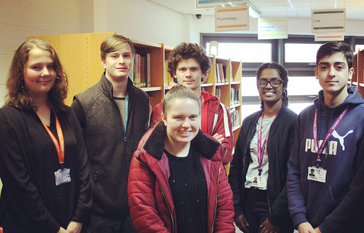 Image of Student volunteers helping schoolchildren improve reading skills