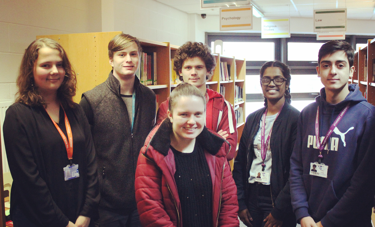 Image of Student volunteers helping schoolchildren improve reading skills