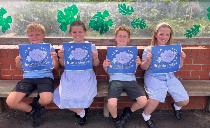 Image of four primary school pupils holding up their winning designs.