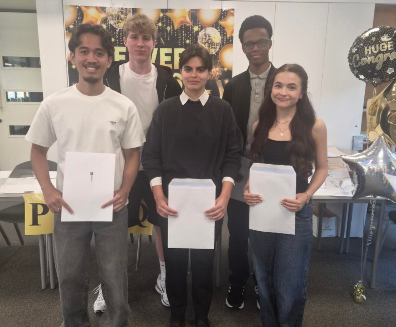 Group of students with their results envelopes