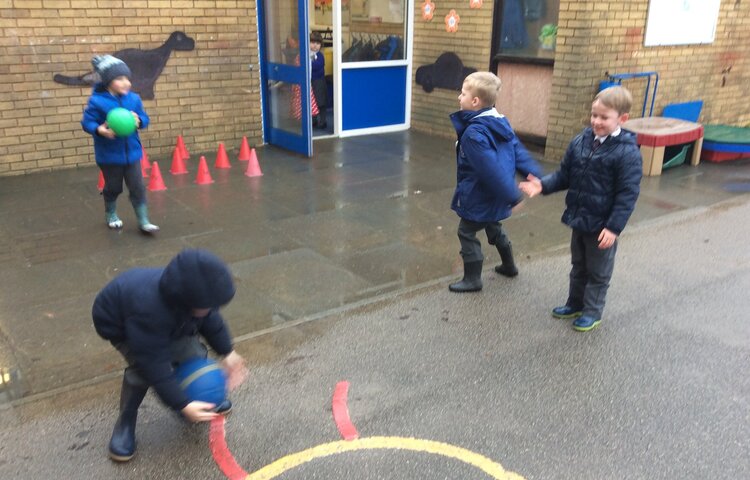 Image of Catching, throwing and rolling outdoors