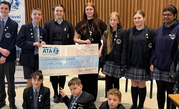 Carmel College students presenting their cheque after delivering their Active Travel Ambassador pitch