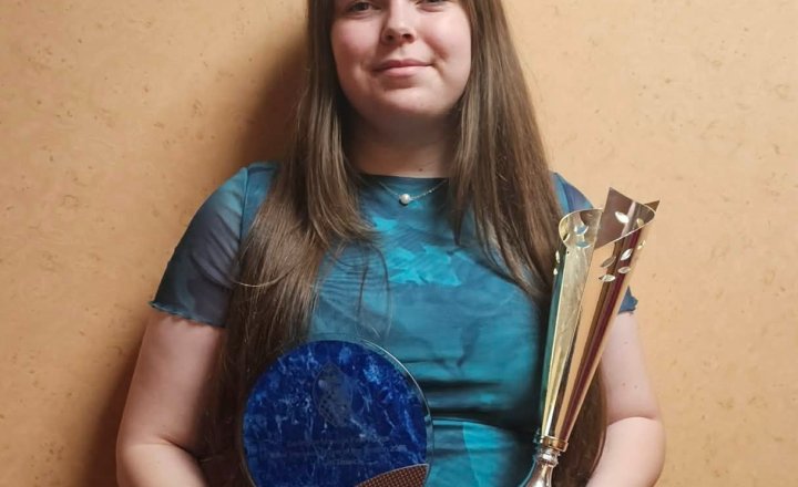 Carmel College Sixth Form student, Faith, celebrating their amazing award for 'Most Improved Player'