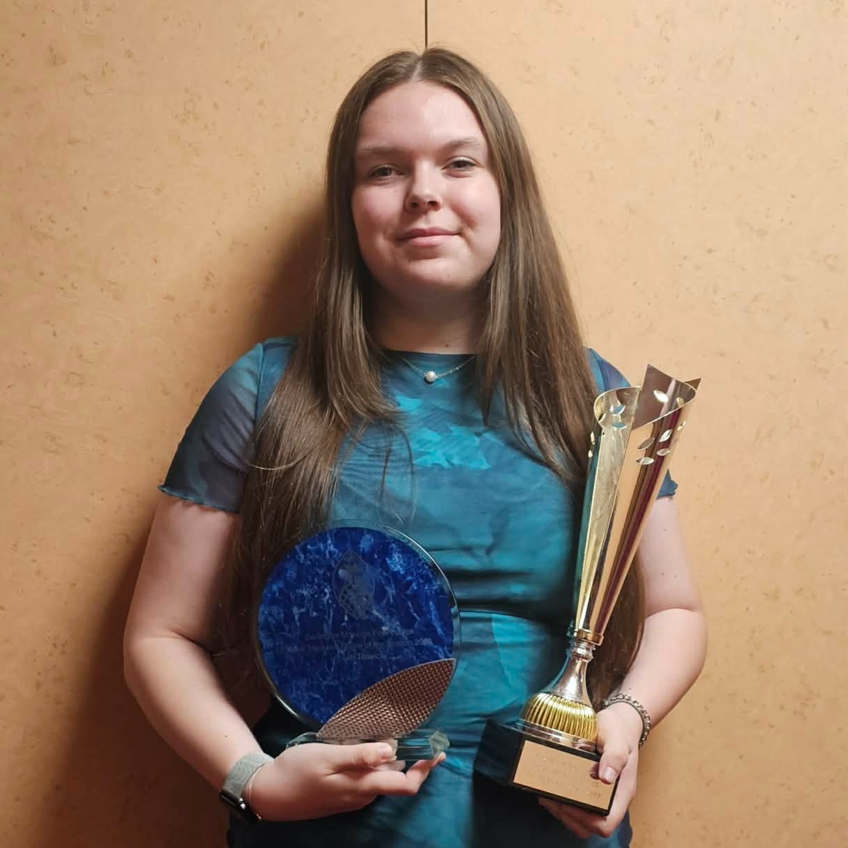 Carmel College Sixth Form student, Faith, celebrating their amazing award for 'Most Improved Player'