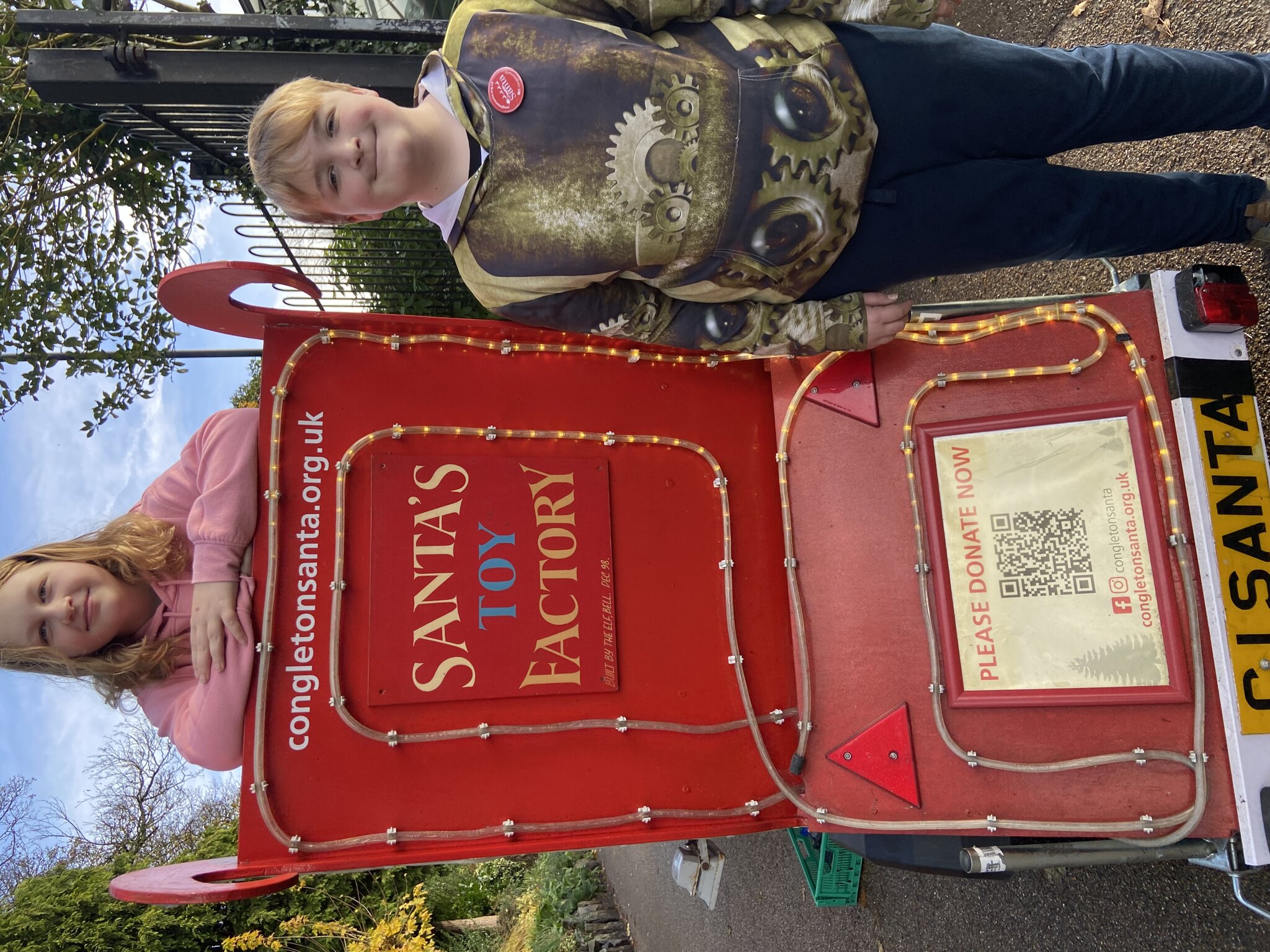 Image of William and Amber Volunteer with Santa!