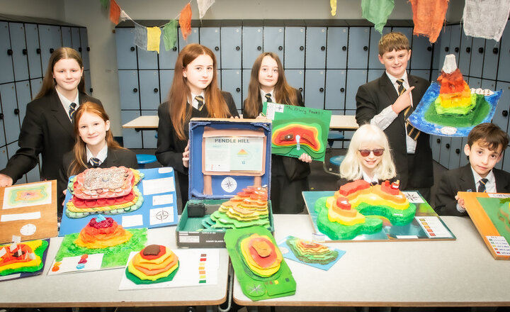Very colourful photo of Year 7 children with their winning contour models. 