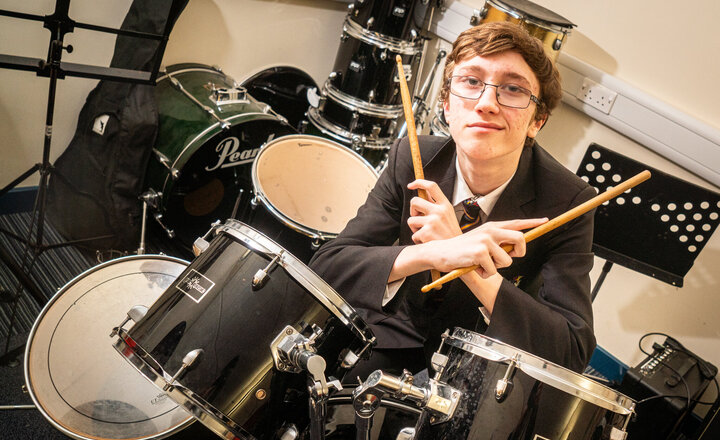 Image of Louis is beating his drums to success