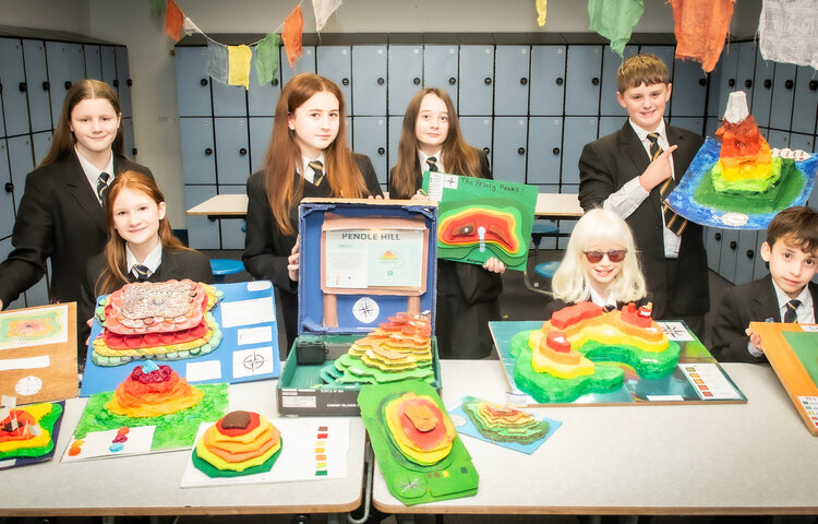 Very colourful photo of Year 7 children with their winning contour models.
