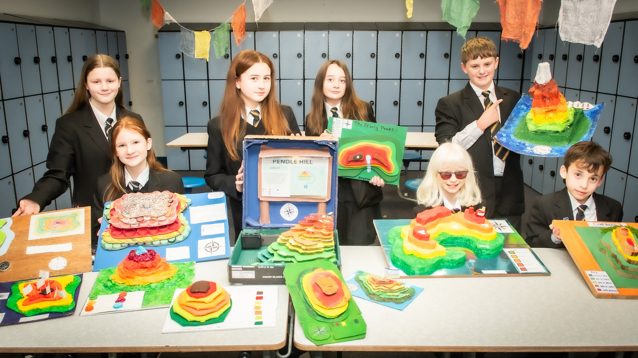 Very colourful photo of Year 7 children with their winning contour models. 