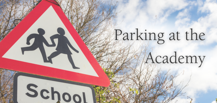 a red warning triangle signpost for school children and the text Parking at the Academy