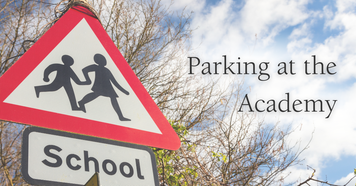 a red warning triangle signpost for school children and the text Parking at the Academy