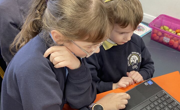 Image of Year 1 get a helping hand from Year 6