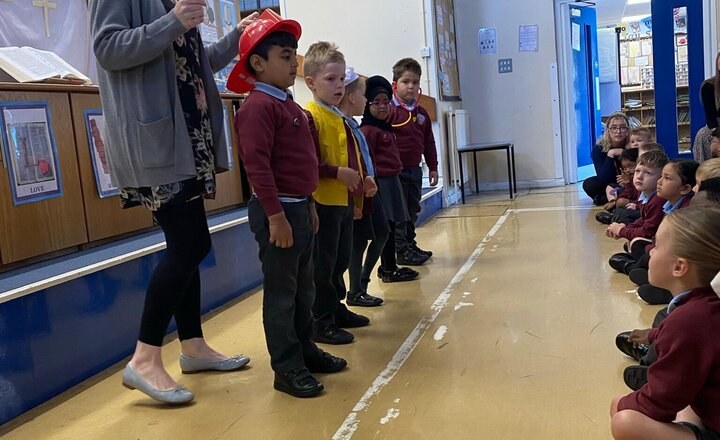 Image of Reception helping Rev Alice in worship today.