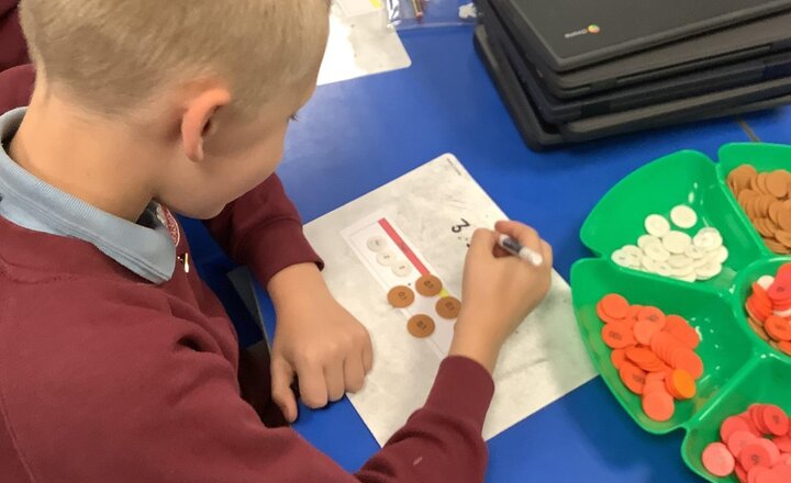 Image of Year 4 mathematicians explored tenths on a place value chart this morning using whiteboards and counters, strengthening their understanding of decimals and wholes.