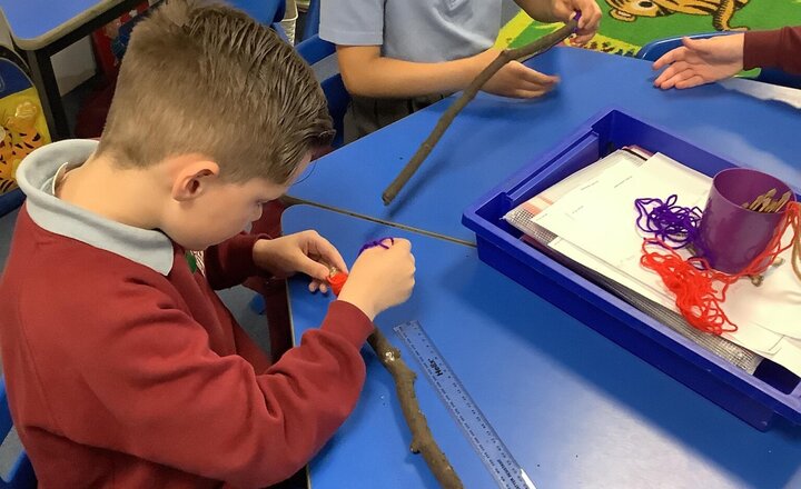 Image of This half term our art topic is Woven Wonders. We have been developing the skill of wrapping with wool using sticks to make magic wands!