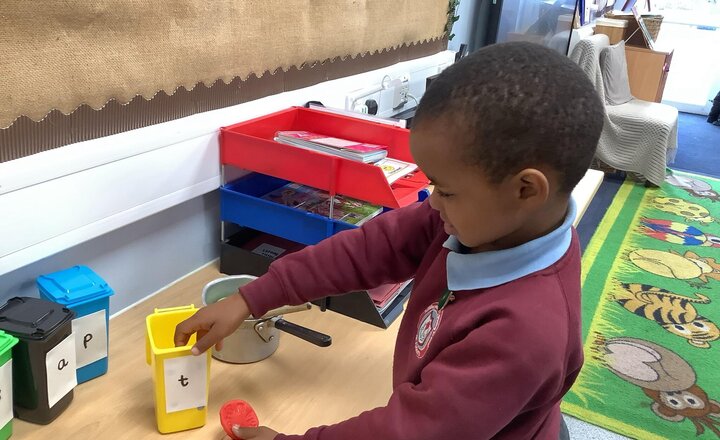 Image of Working hard on initial sounds in phonics.