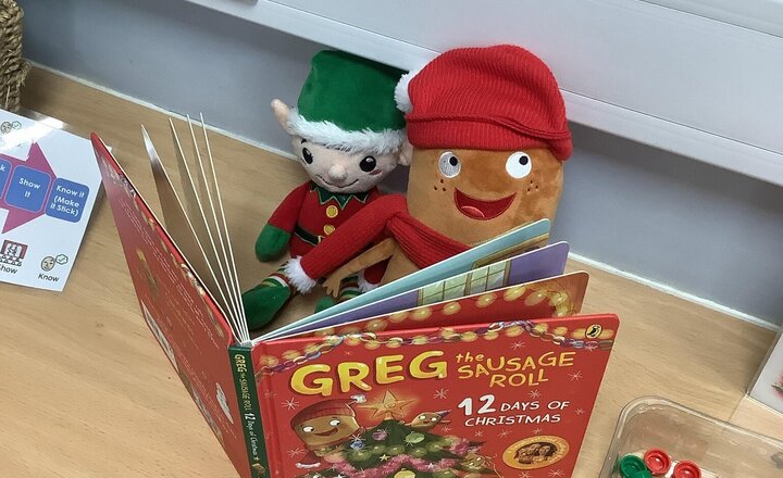 Image of We had a very special visitor that came with the elf today! It’s Greg the sausage roll! Reading their favourite Christmas book together.