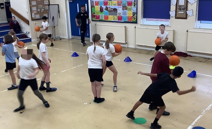 Image of This half term, we are focusing on basketball skills in our PE sessions.