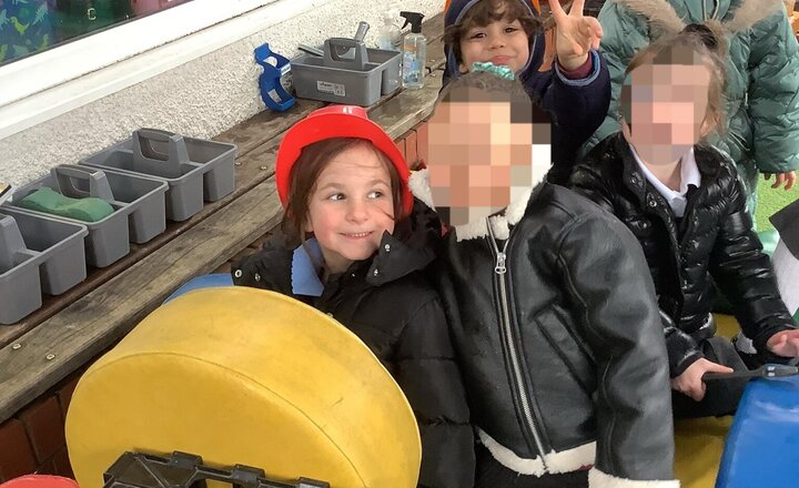 Image of Working hard as a team building a bus outside!