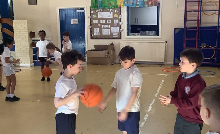 Image of Such a busy day, in PE we are learning basketball skills..team work is needed and ball control.  As you can see we are smashing it!