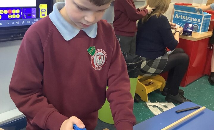 Image of This morning, we researched Electric Vehicles, investigating the best materials and assembly methods for our chassis. Our budding carpenters also put their skills to the test, learning how to use a hacksaw with precision.