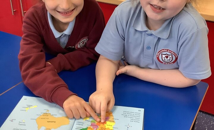 Image of Geography: Exploring Zambia. We recapped the continents and oceans before locating Zambia on our globes and atlases. The children discovered it is part of Africa. We look forward to comparing Zambia with our local area, Mill Hill, over the coming weeks.