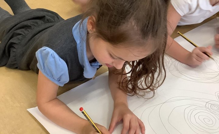 Image of Year 1 kicked off our new Art unit on spirals this week! 🌀 The children explored drawing spirals of different sizes using their fingers, wrists, and arms. We can’t wait to try out new techniques and mediums over the next few weeks!