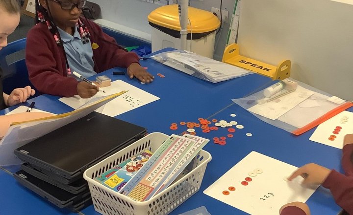 Image of Today in maths we are working on making hundreds tens and ones, the challenge set is to use 8 counters only 💫