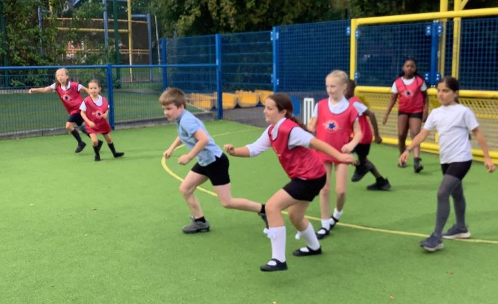 Image of This week in PE, we explored how equipment affects strategy. Playing handball and football with different balls, pupils adapted their movement and passing for bounce, weight, and size—reflecting brilliantly on how to adjust their gameplay! ⚽