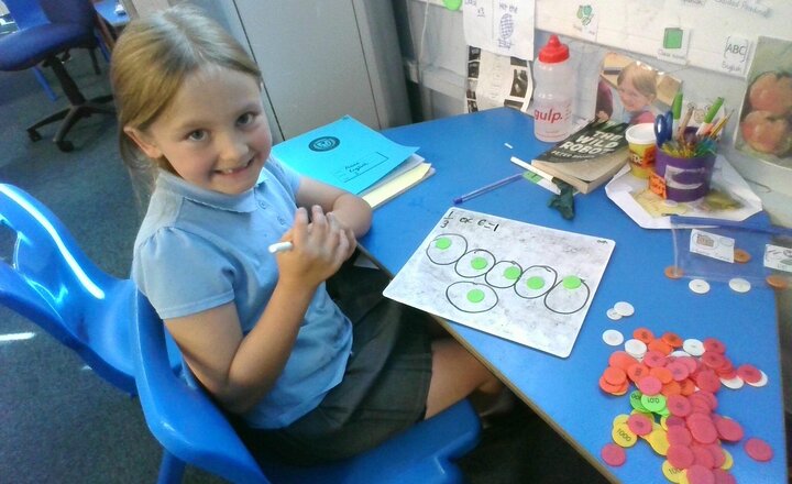 Image of This morning in maths we have been finding fractions of numbers using place value counters.