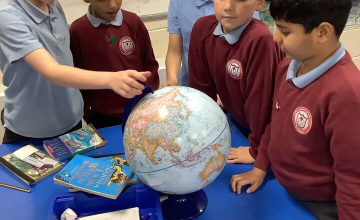 Image of Exploring mountains using globes and atlases in Geography.