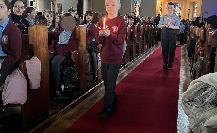 Image of Some of the pictures of our Year 4 children taking part in our Carol Concert service this morning in church. They made the christingles in their RE lessons.