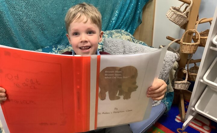 Image of Enjoying a book by Reception in the reading area.