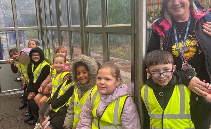 Image of The rain won’t dampen our spirits. We are so excited to get on the train and go to Blackburn Youth Zone, we can’t wait for a morning full of activities.