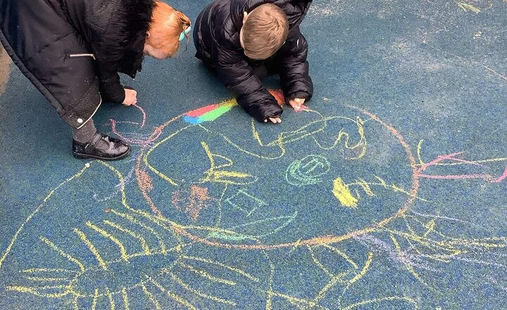 Image of Diwali- making Rangoli Patterns with chalk on the ground.