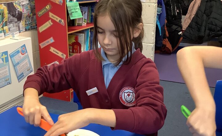 Image of We put our chopping skills to the test, carefully preparing the ingredients for our delicious bolognese sauce. Great teamwork, everyone!