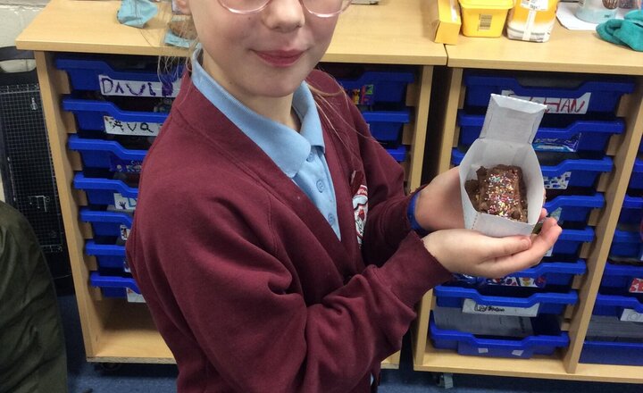 Image of Next, the children designed their biscuit package by drawing their design onto a net. They then cut out the net and put the pieces together to form the final package.