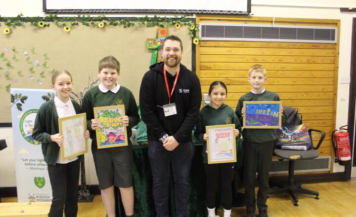 St. Augustine's pupils receiving their framed designs for winning the Sleeping Beauty programme design competition 