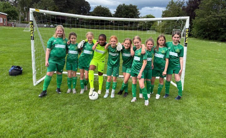 St Augustine's girls' football team showing their teamwork and determination on the pitch