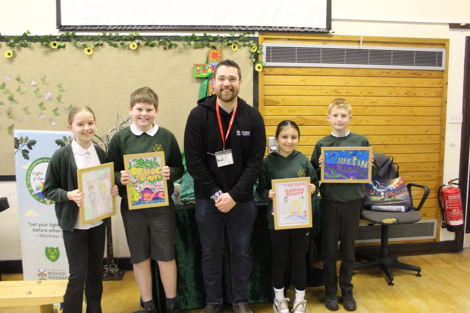 St. Augustine's pupils receiving their framed designs for winning the Sleeping Beauty programme design competition 