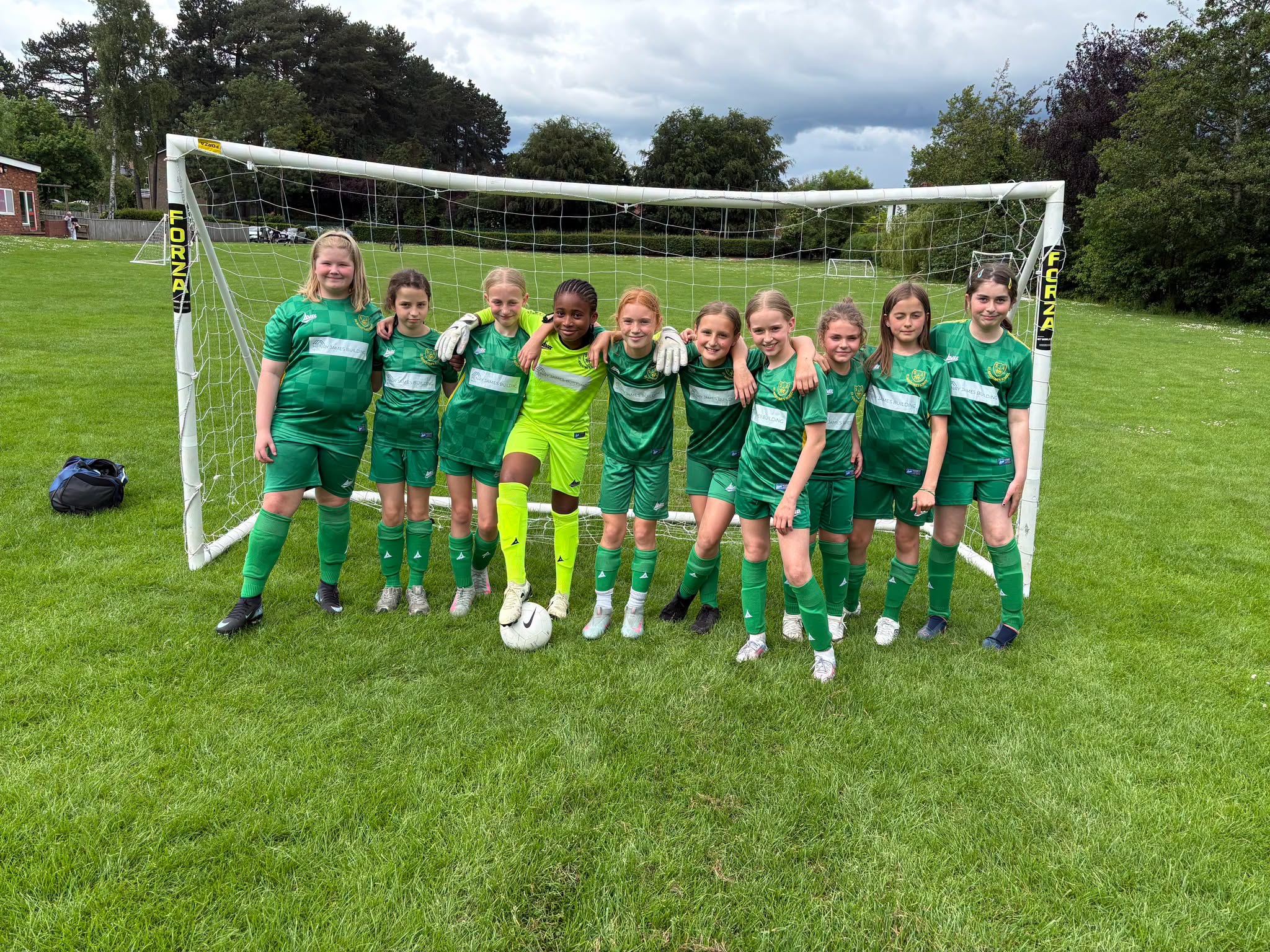 St Augustine's girls' football team showing their teamwork and determination on the pitch
